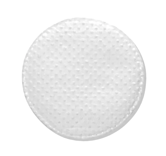 A close-up view of the pre-soaked Acne Control Pad, a round white object with a textured surface on a white background