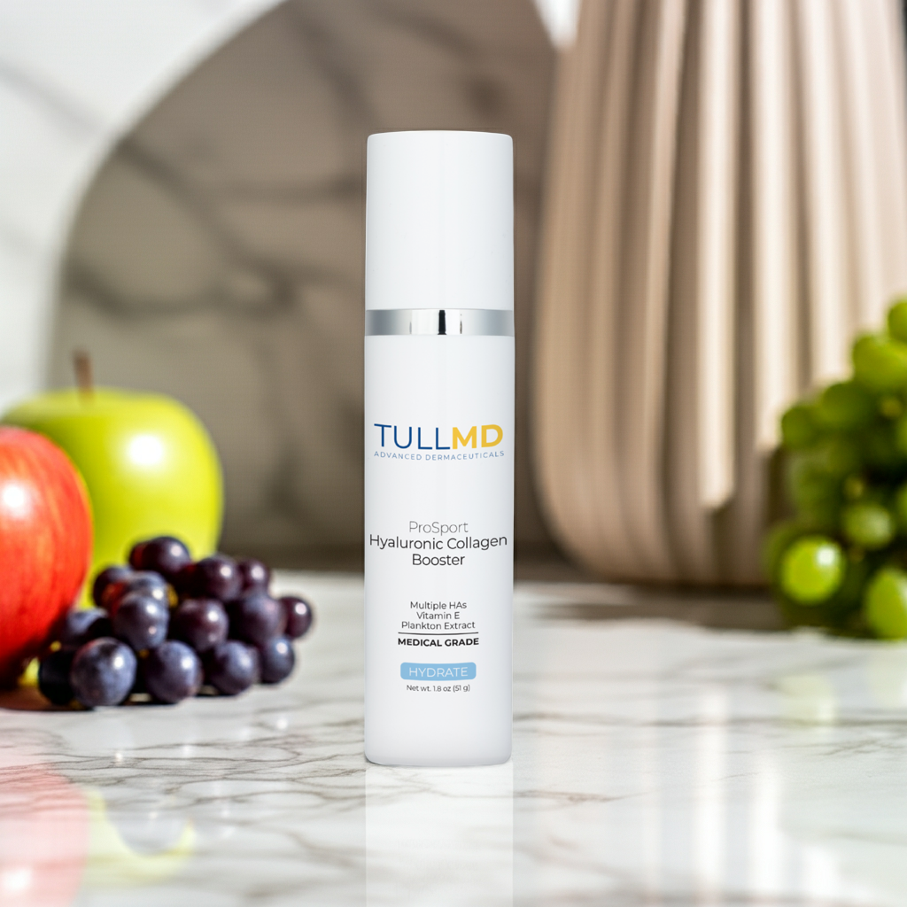 ProSport Hyaluronic Collagen Booster on a table with some of the ingredients: apples and grapes.